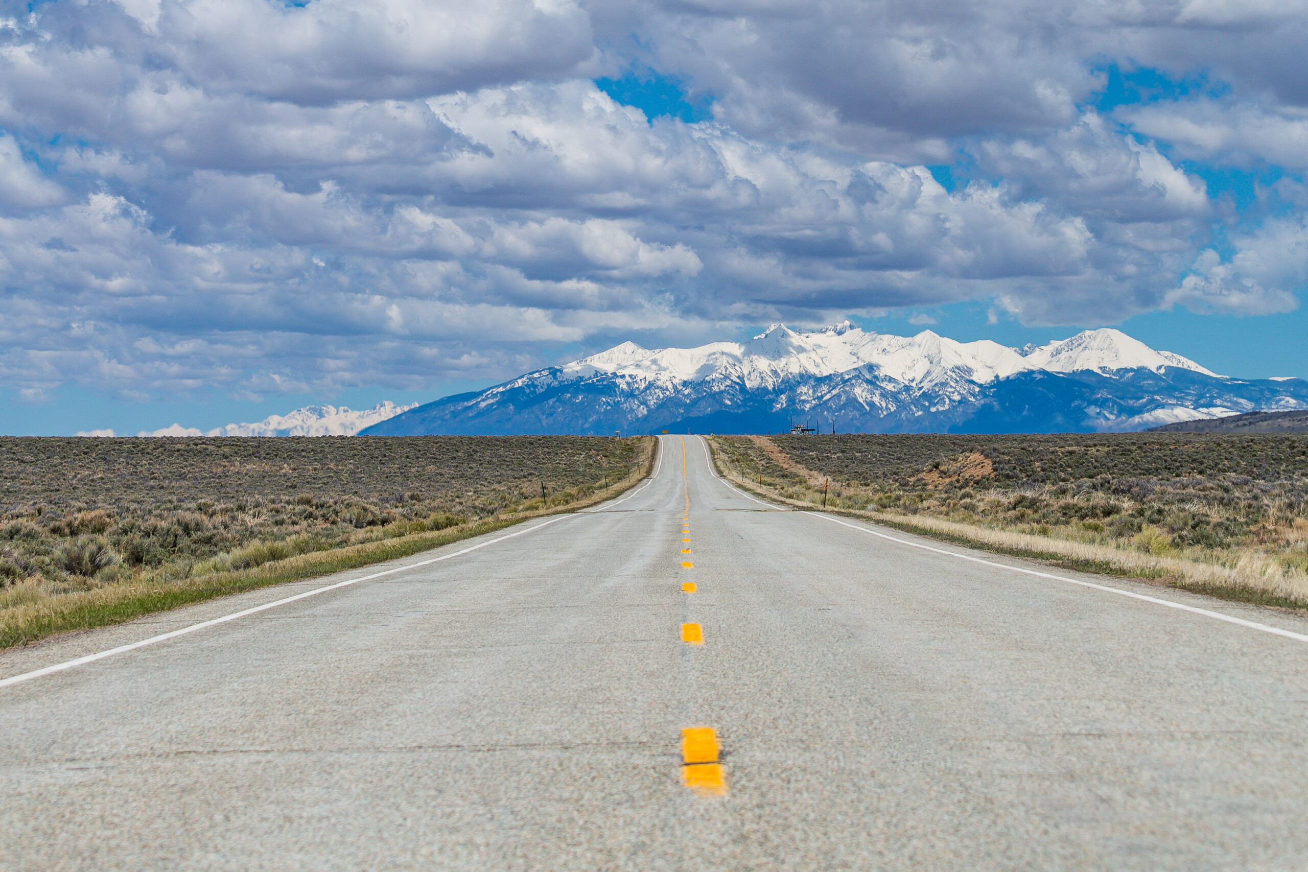 mountains at the end of an open road