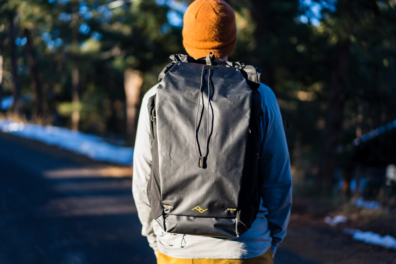peak design outdoor backpack 45l in black in a forest backdrop